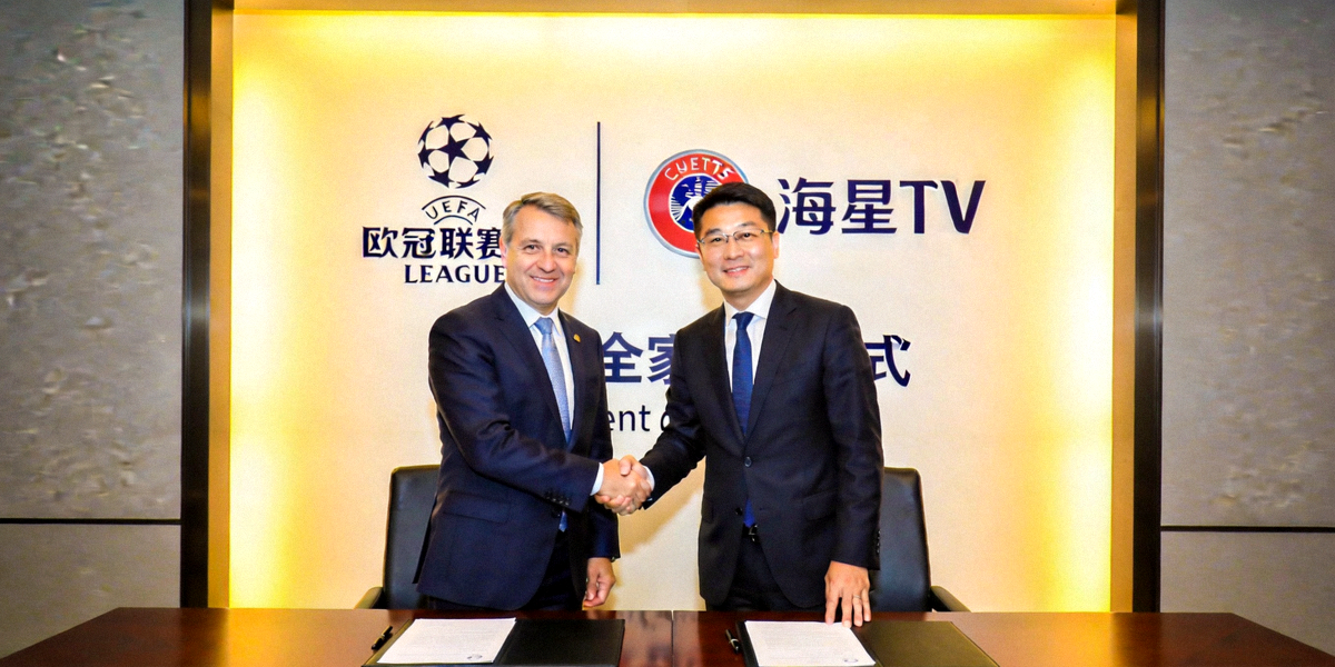 欧冠联赛与海星TV独家签约仪式现场照片，双方代表握手庆祝